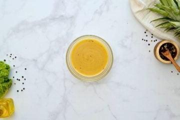 Orangensaft, Jerk-Gewürz, Reisweinessig und Olivenöl werden zu einer Orangen-Vinaigrette verquirlt.