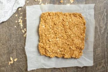 Erdnussbutter-Haferflocken-Riegel auf Backpapier.