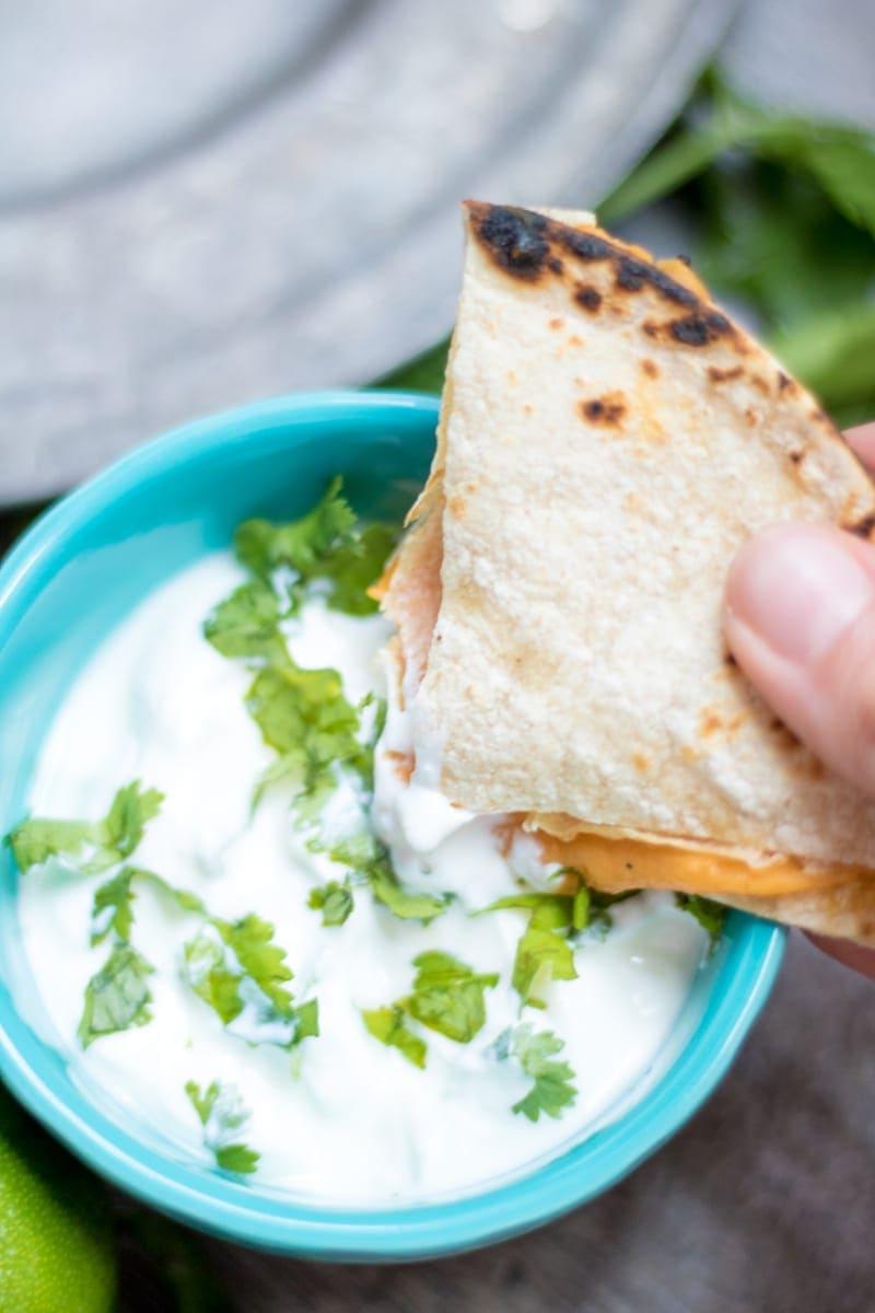 Kleinkind Quesadilla Healthy Quesadilla being dipped into cilantro sour cream.