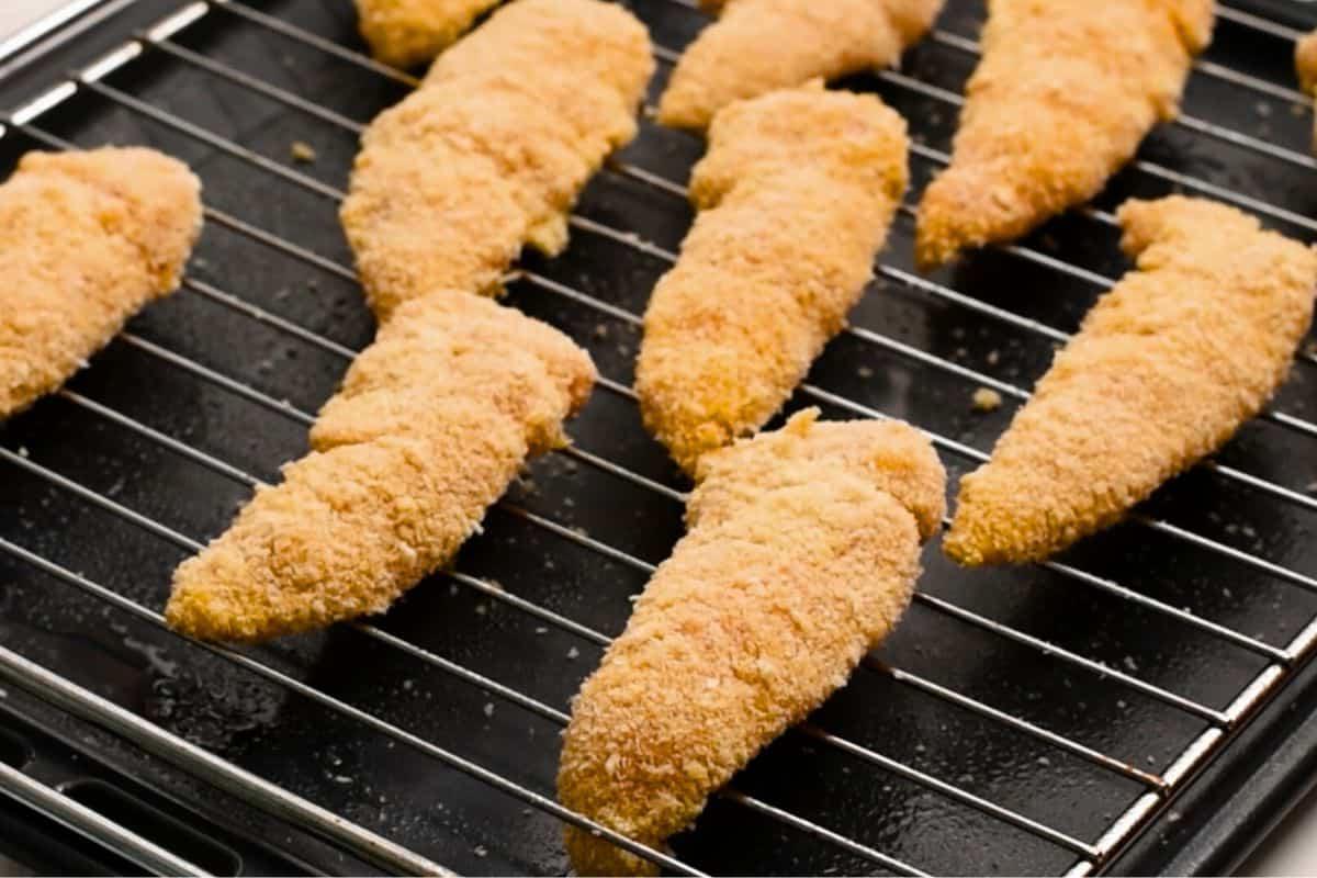 Baked Crispy Chicken Tenders on rack over baking sheet. 