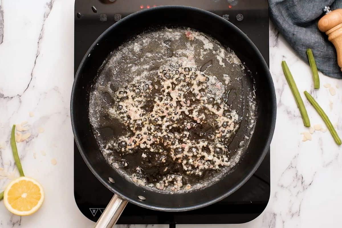 Angeschwitzte Schalotten in einer Sauteuse nach dem Braten in Butter.