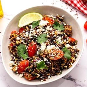 Quinoa Mexican Salad with Feta, Beans and Tomatoes in white bowl
