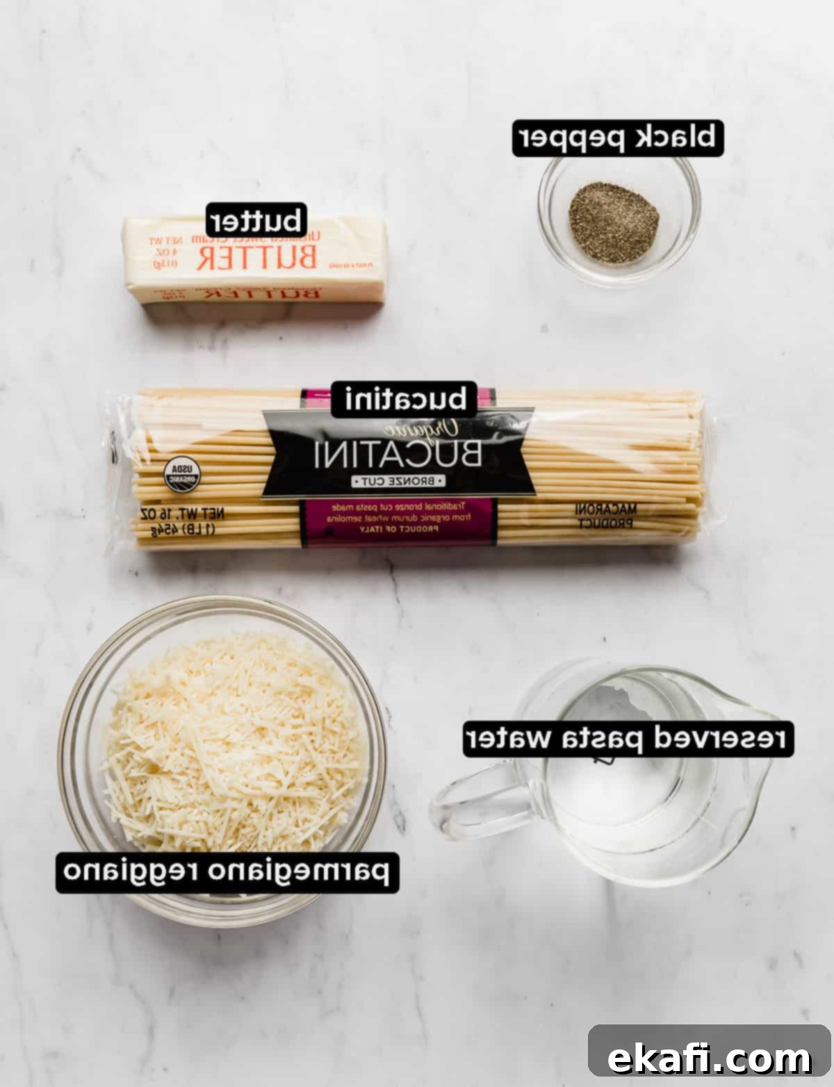 Μπουκατίνι Κάτσο ε Πέπε 3 Bucatini Cacio e Pepe ingredients laying on a white background.