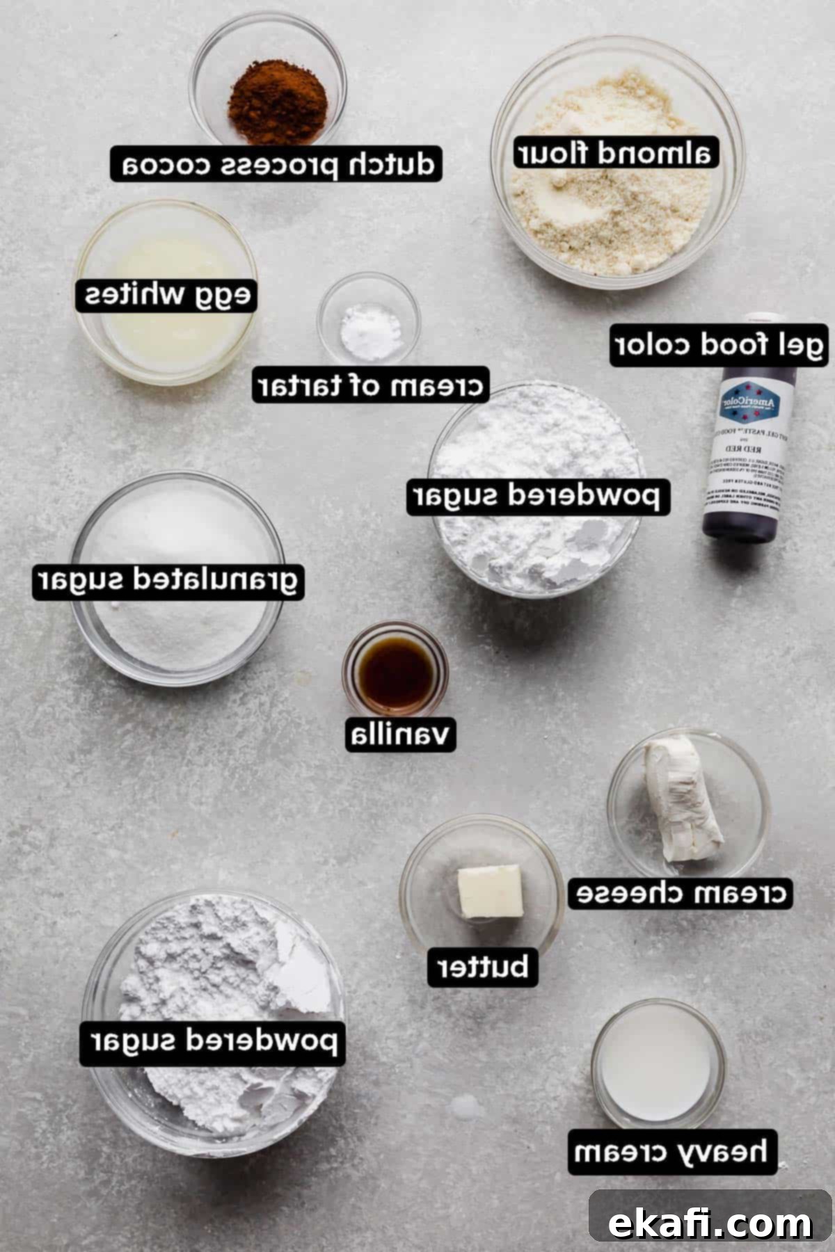 Μακαρόν Κόκκινο Βελούδο 3 Ingredients used to make Red Velvet Macarons, each ingredient portioned into glass bowls on a gray background.