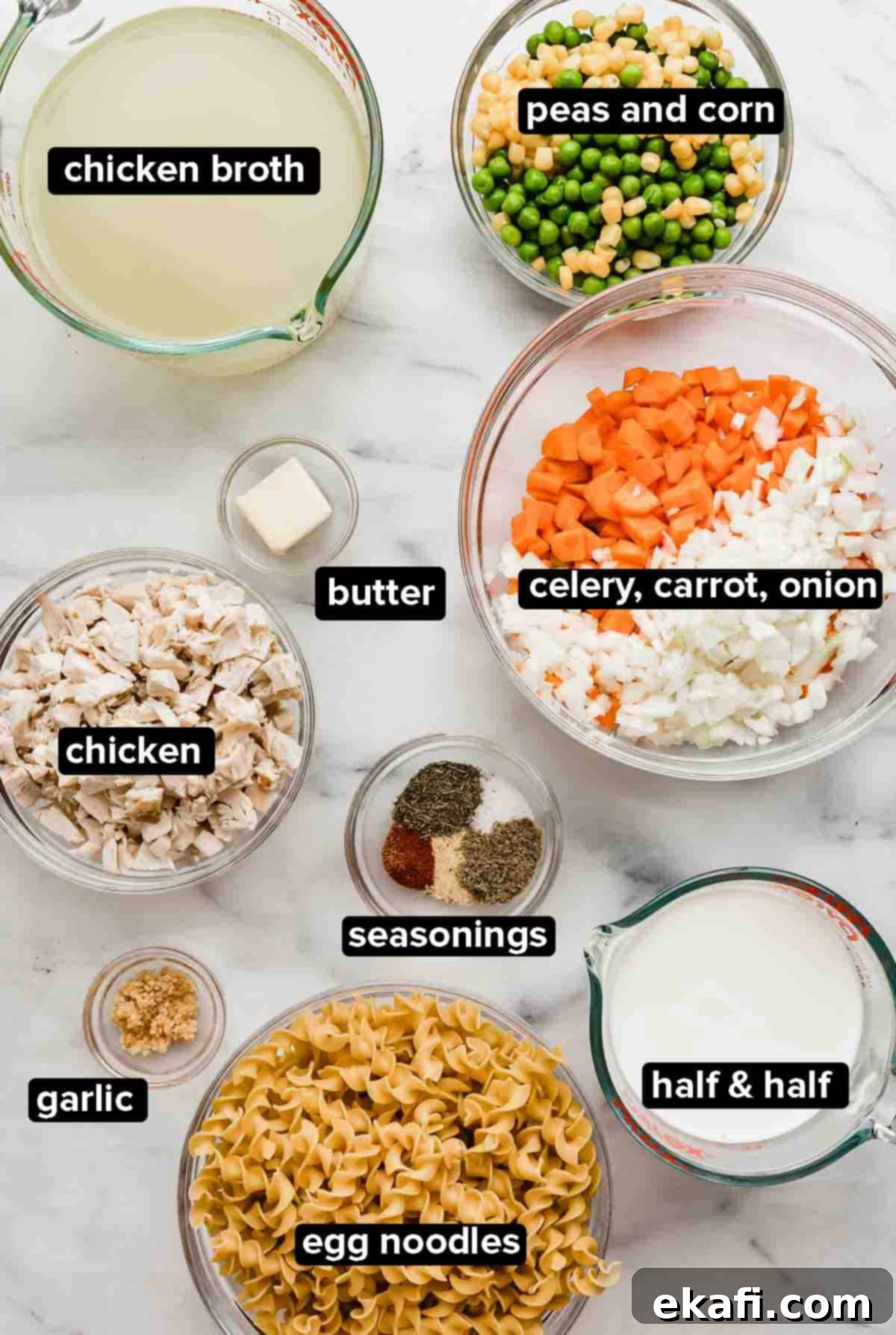Creamy Chicken Pot Pie Noodles 3 Chicken Pot Pie Noodles ingredients on a white marble background.