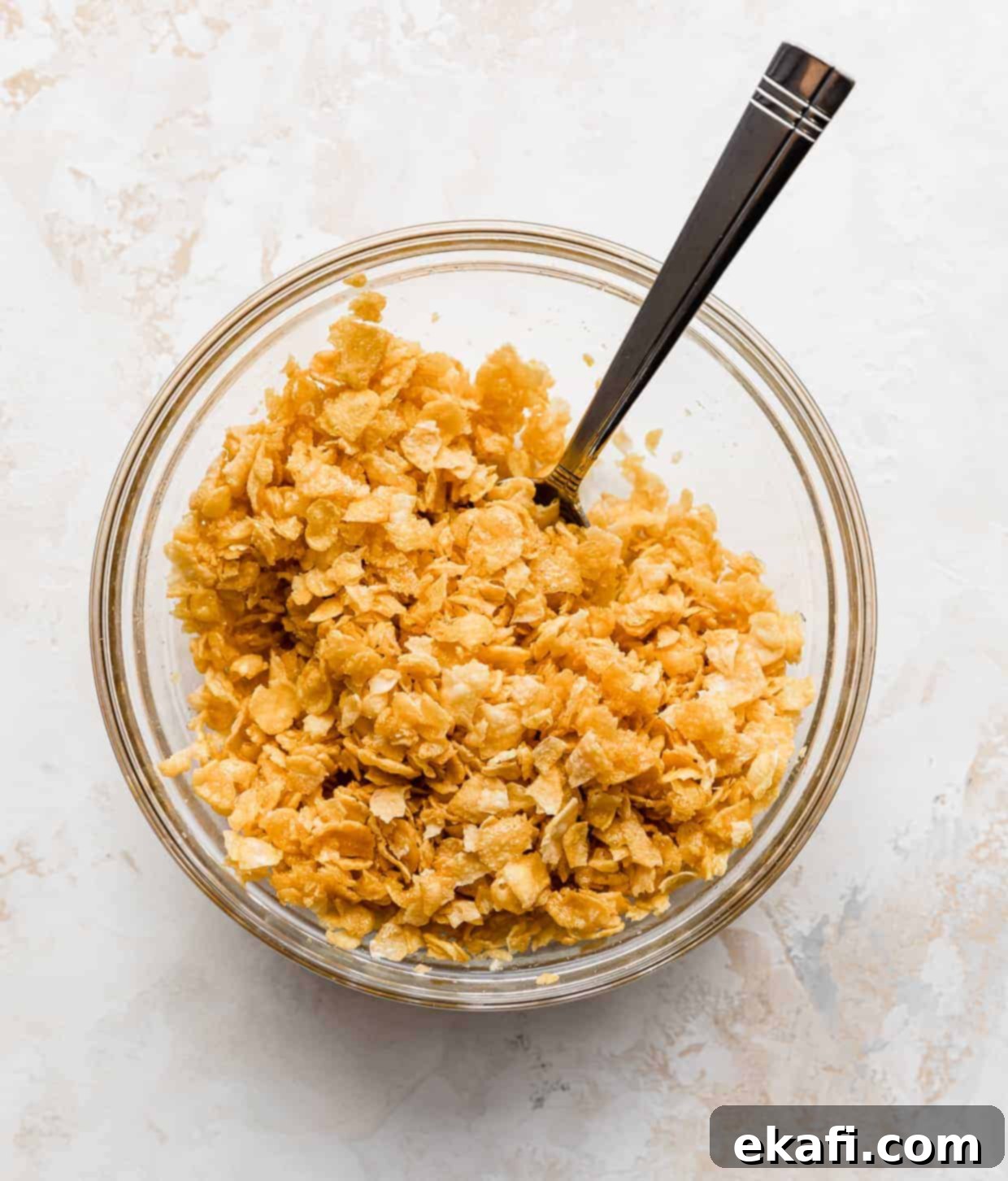 Soul-Soothing Spuds 7 A glass bowl with slightly crushed cornflakes mixed with melted butter for the topping.