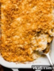Soul-Soothing Spuds 10 Overhead photo of Funeral Potatoes baked in a white rectangular dish.