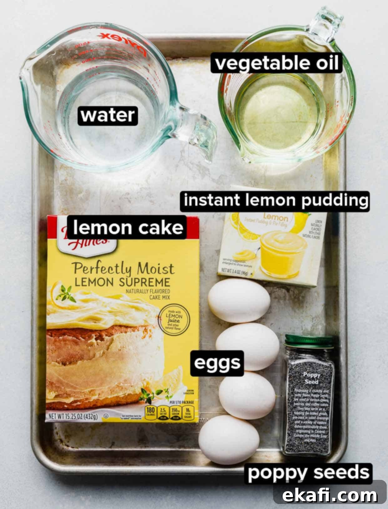 Cake Mix Lemon Poppy Seed Loaf 3 Lemon Poppy Seed Bread ingredients portioned into glass bowls on a metal baking sheet.