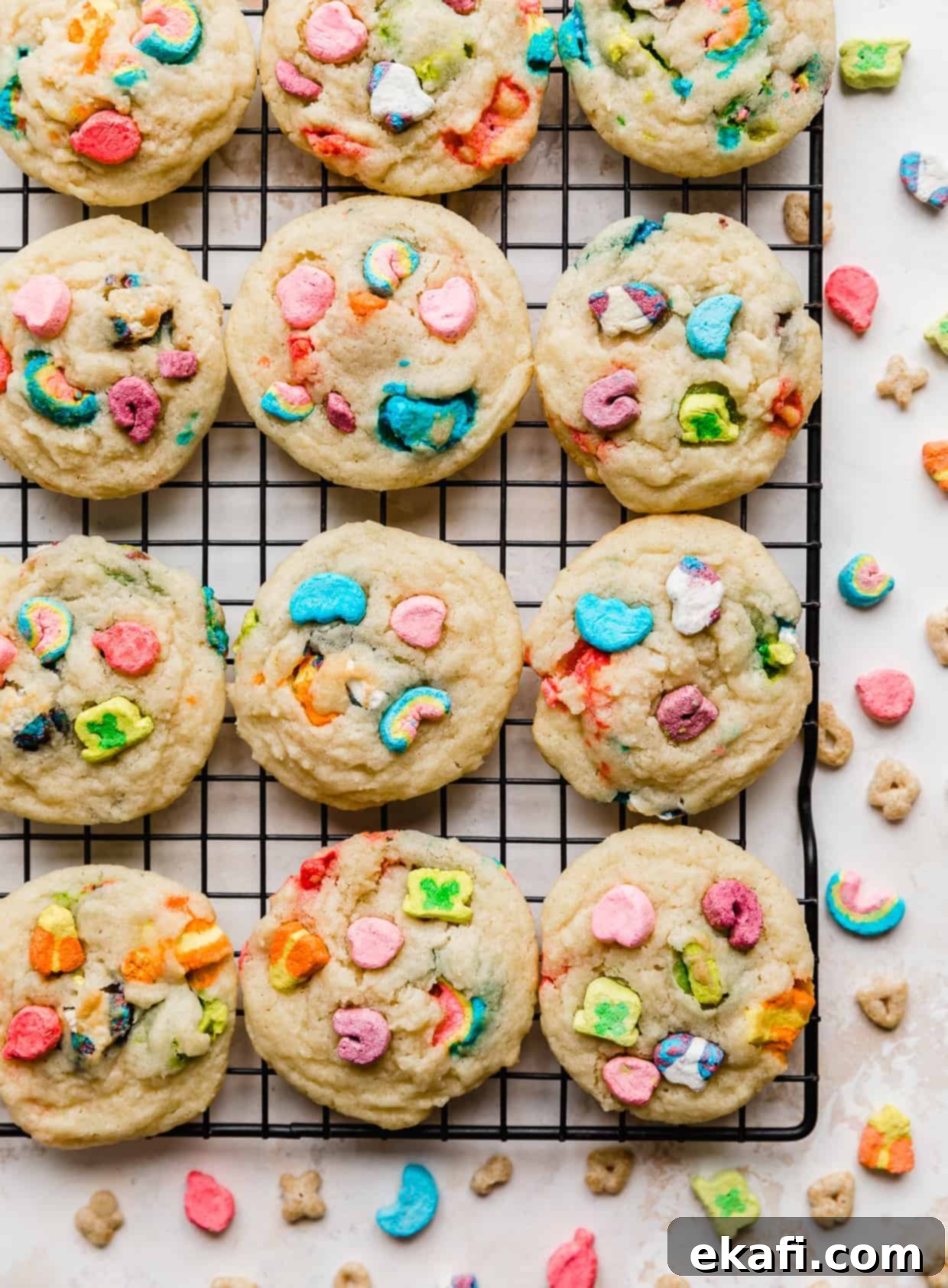 Magic Lucky Charms Cookies 11 Baked sugar cookies on a black wire rack with Lucky Charms marshmallows baked into and pressed onto the cookies.