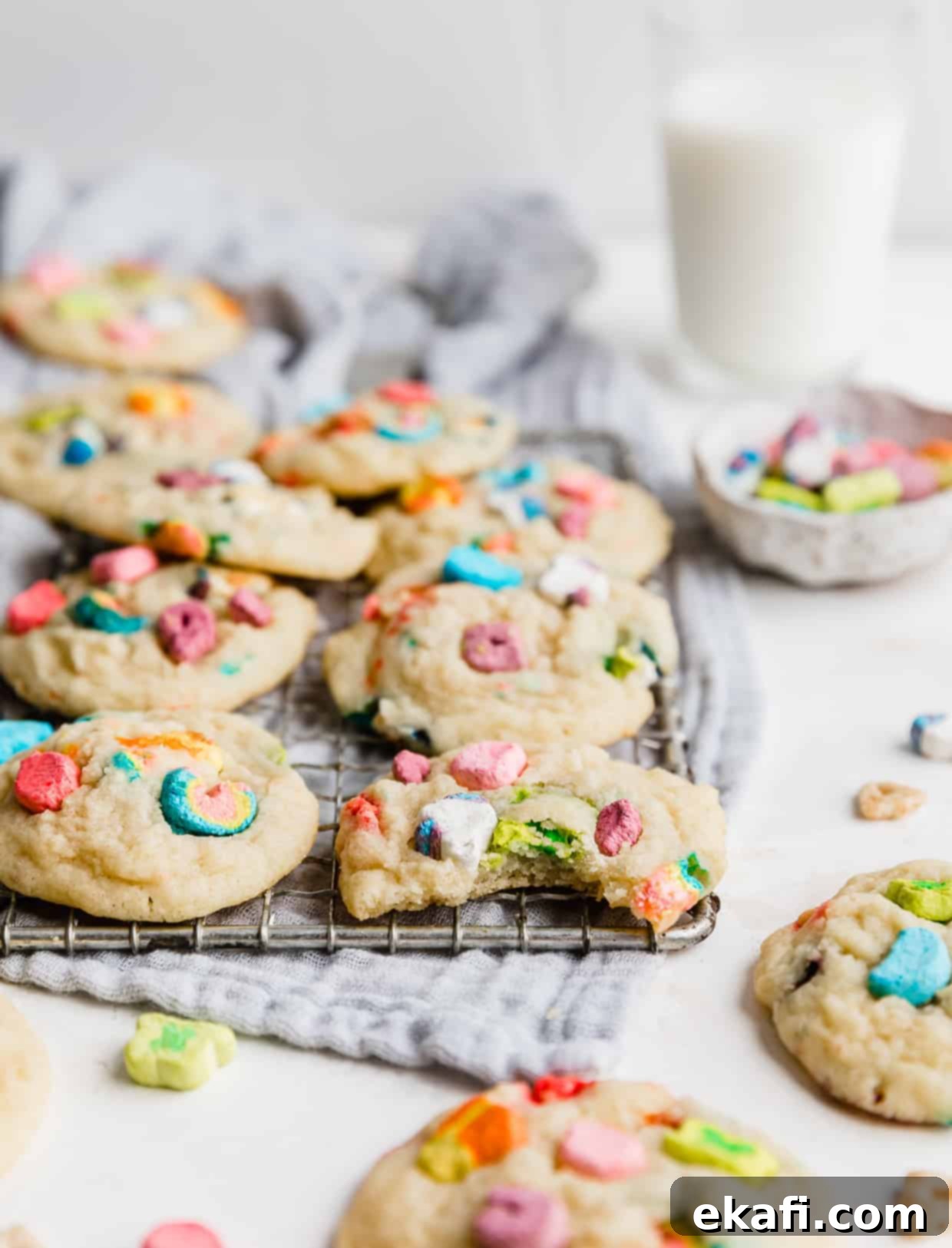 Magic Lucky Charms Cookies 12 A bite taken out of a Lucky Charm sugar cookie, with the cookie resting on a wire rack, showing its soft interior.