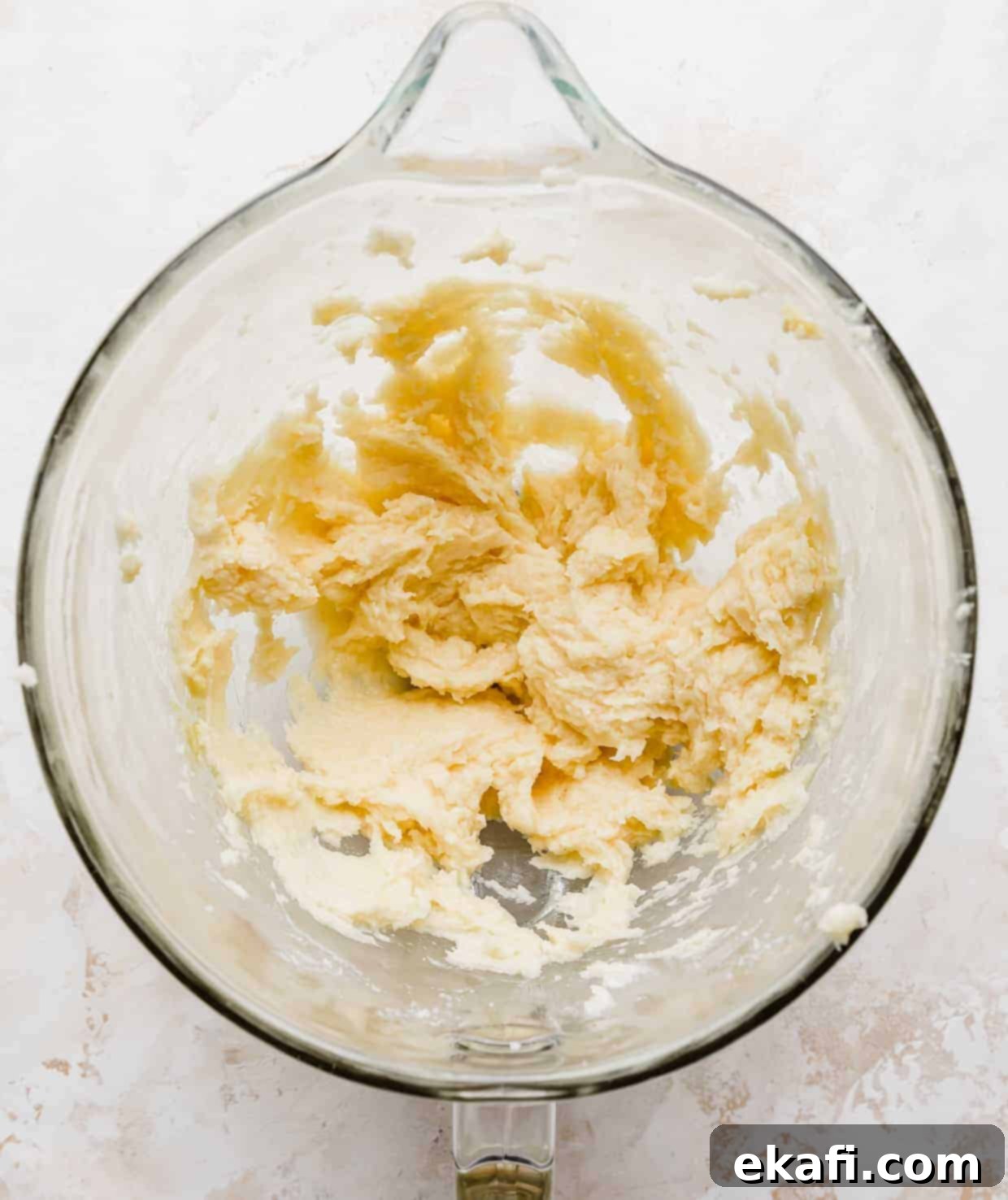 Magic Lucky Charms Cookies 5 Overhead photo of a glass mixing bowl with creamed sugar cookie dough in it, smooth and pale.