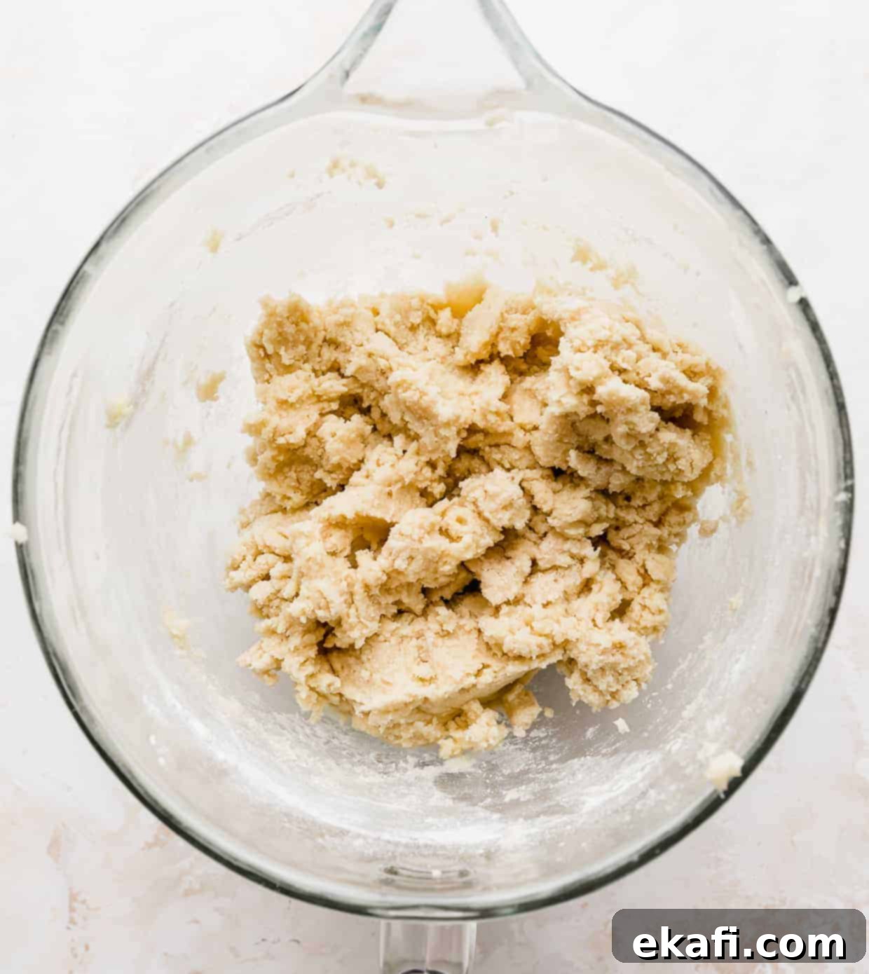Magic Lucky Charms Cookies 7 Sugar cookie dough in a glass mixing bowl against a white background, smooth and ready for marshmallows.