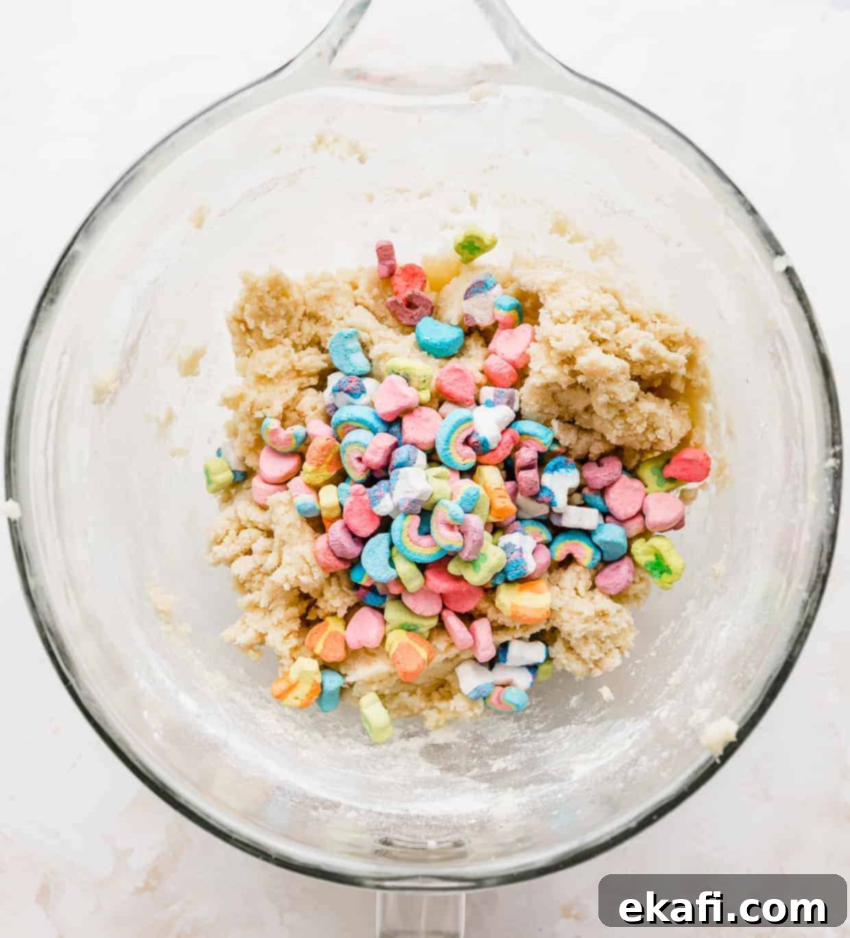 Magic Lucky Charms Cookies 8 Lucky Charms cereal marshmallows in a glass bowl against a white background, ready to be added to the dough.