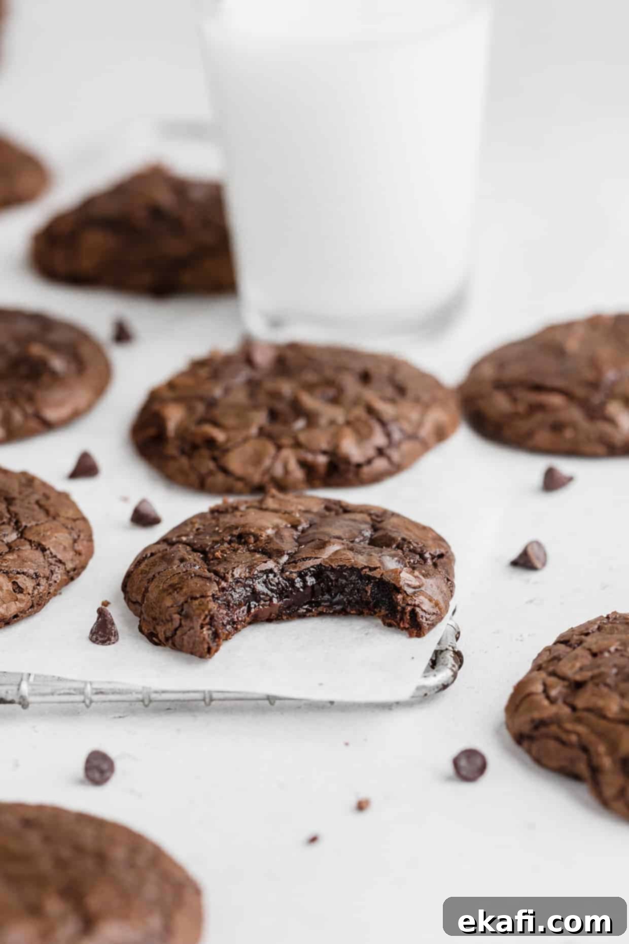 Fudgy Brownie Cookies 10 A bite taken out of a brownie cookie, clearly showing its rich, dark, and incredibly fudgy center.