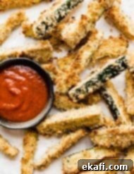 Crispy Baked Zucchini Fries 9 Crispy zucchini fries on a white plate.