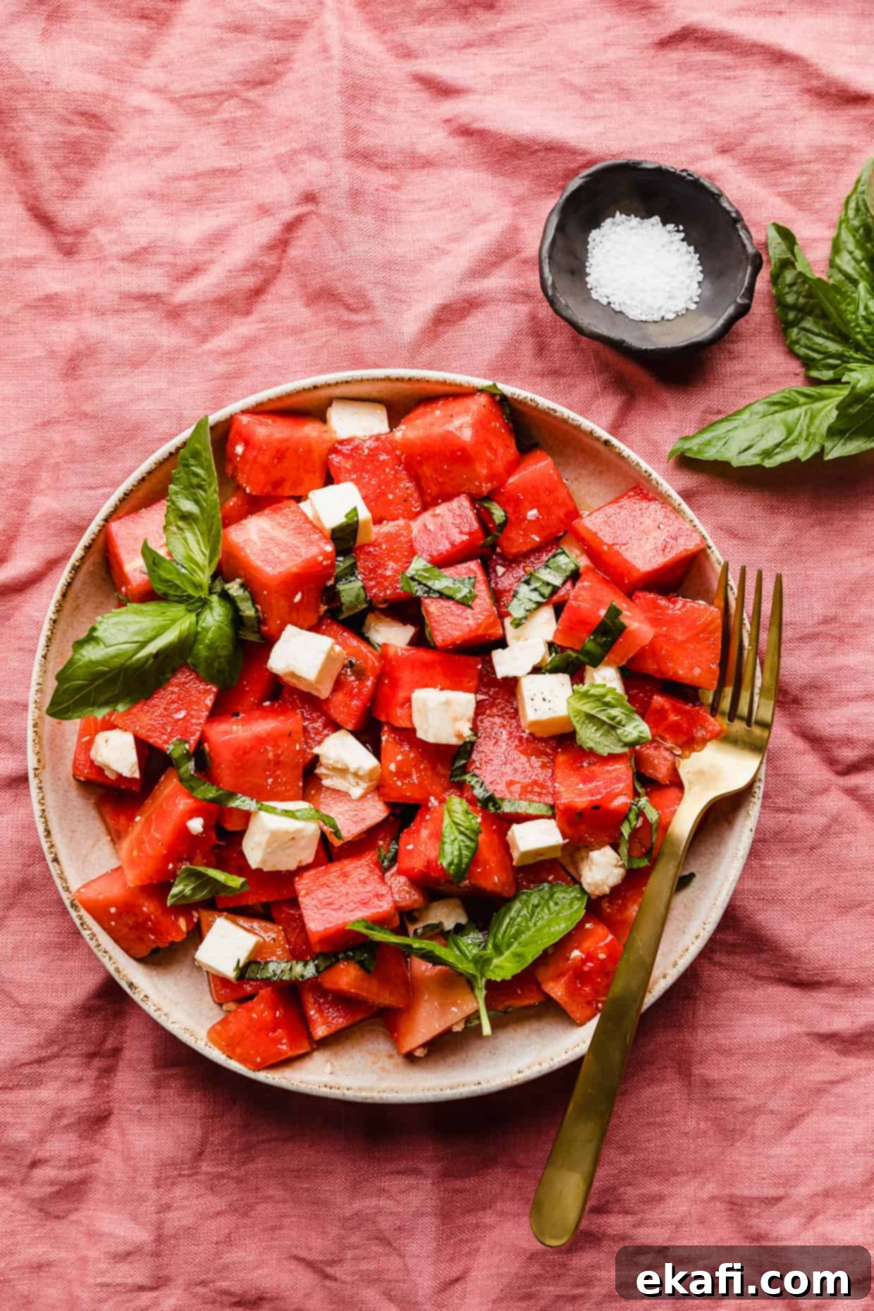 Watermelon Feta Basil Harmony 2 A vibrant Watermelon Feta Basil Salad served on a large white plate, garnished with fresh basil leaves.