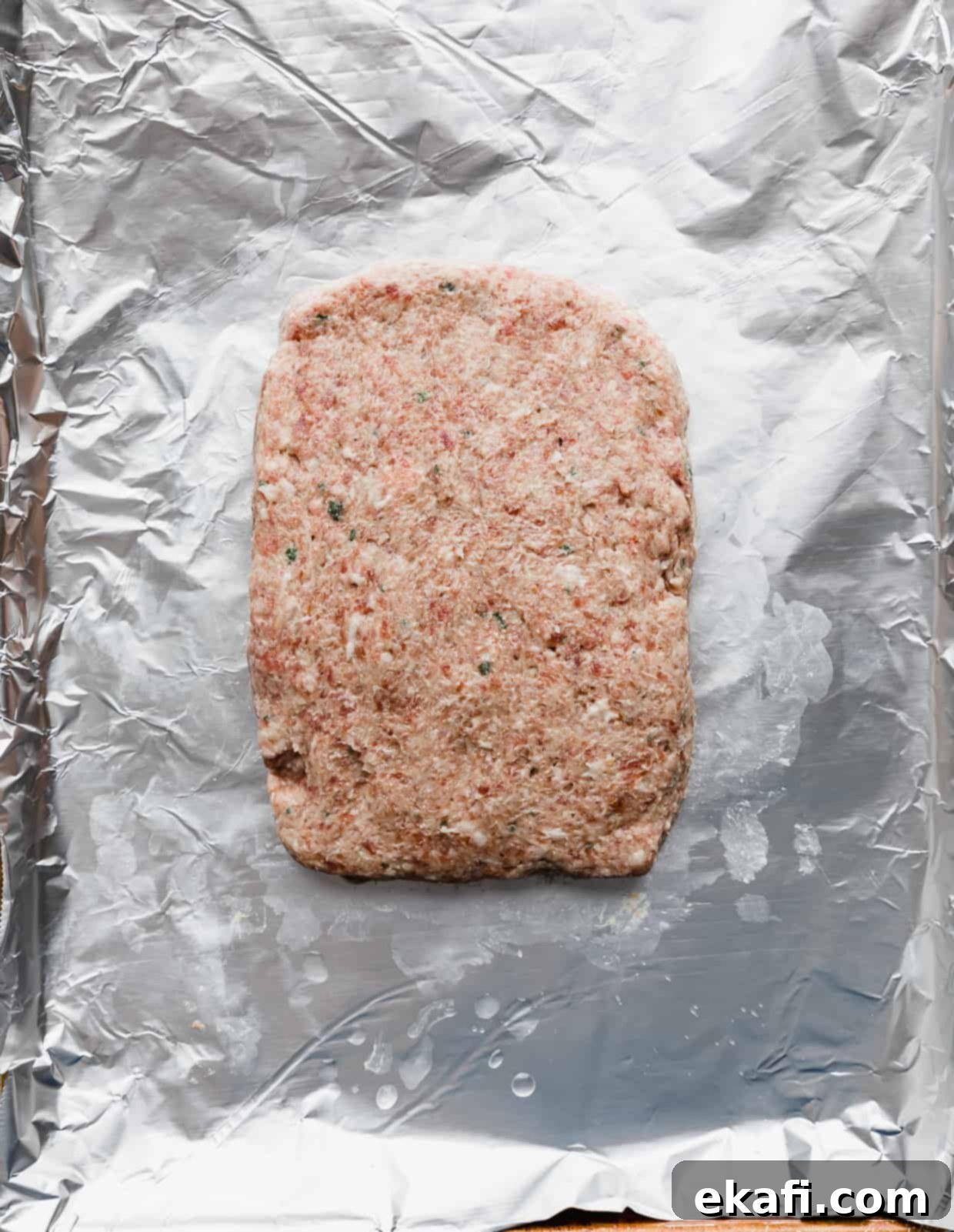 Mediterranean Lamb Gyros 6 Raw lamb gyro meat mixture shaped into a neat rectangle on a foil-lined baking sheet, ready for baking.