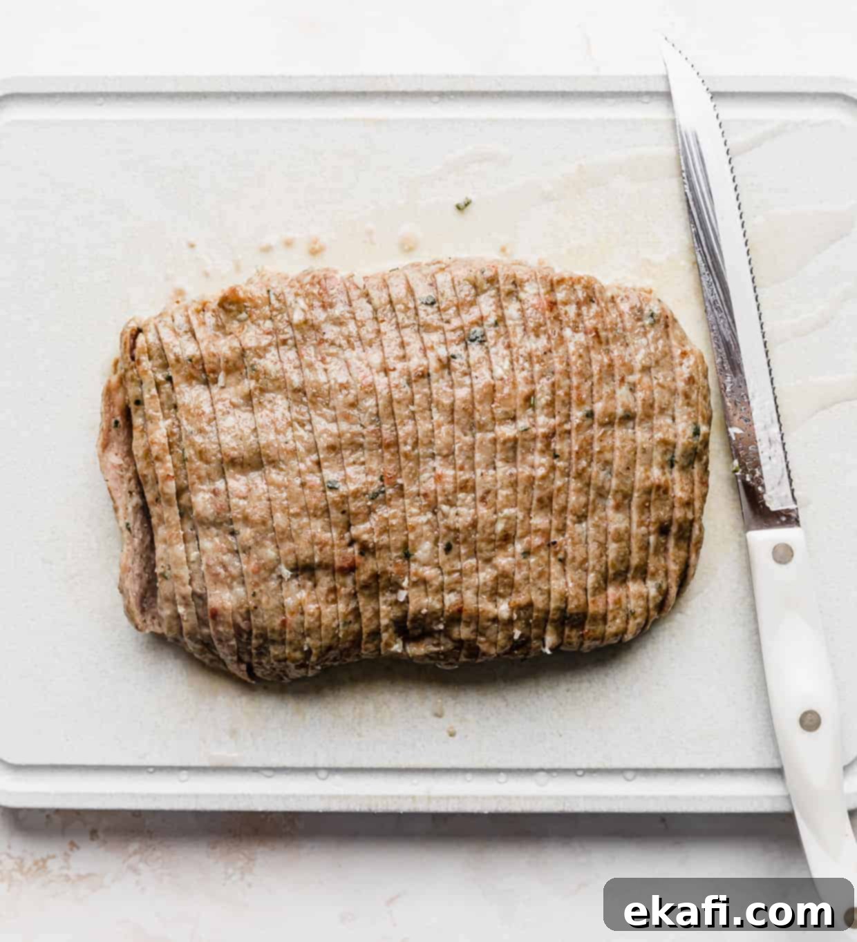 Mediterranean Lamb Gyros 7 A rectangle piece of cooked lamb, thinly sliced into strips, ready for broiling.