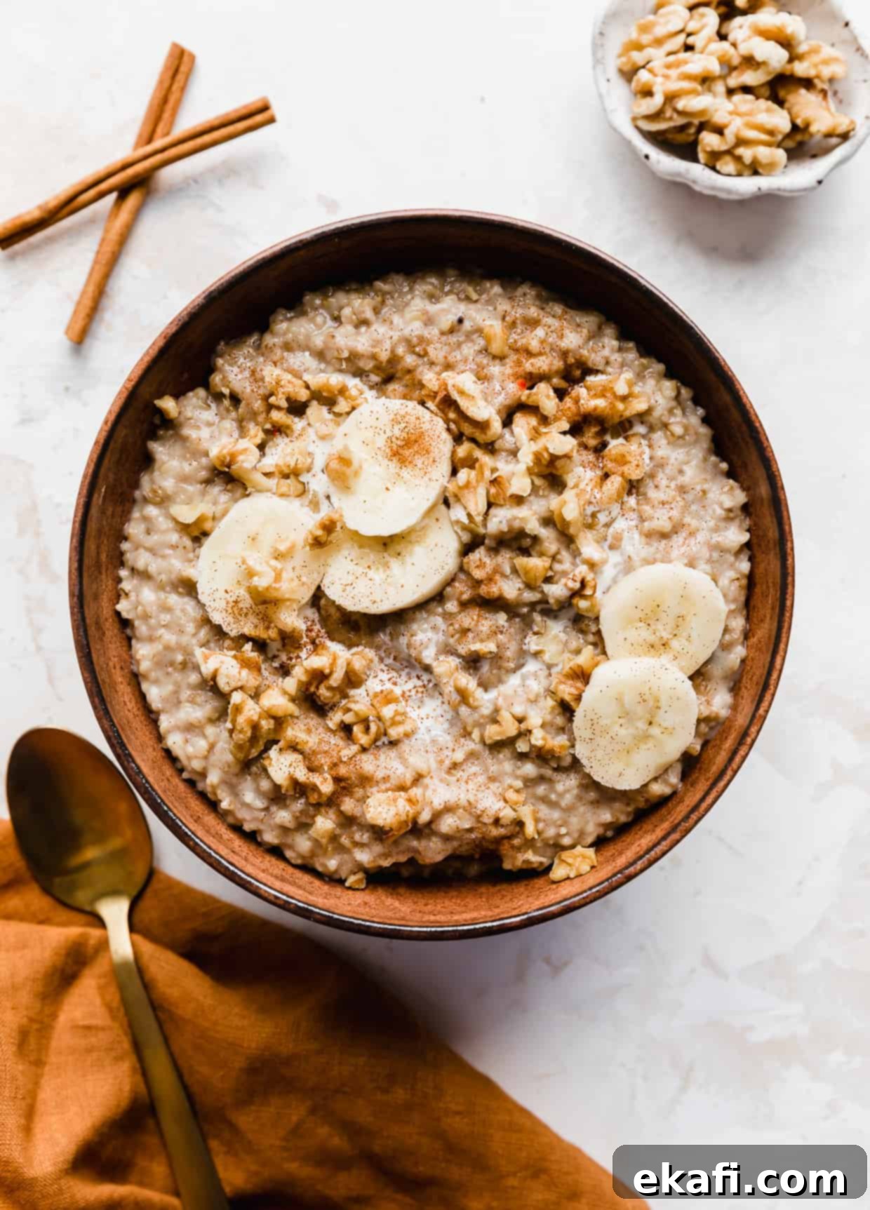 Banana Steel Cut Oat Delight 10 A bowl of Banana Steel Cut Oats against a white textured background, showcasing its appealing presentation.