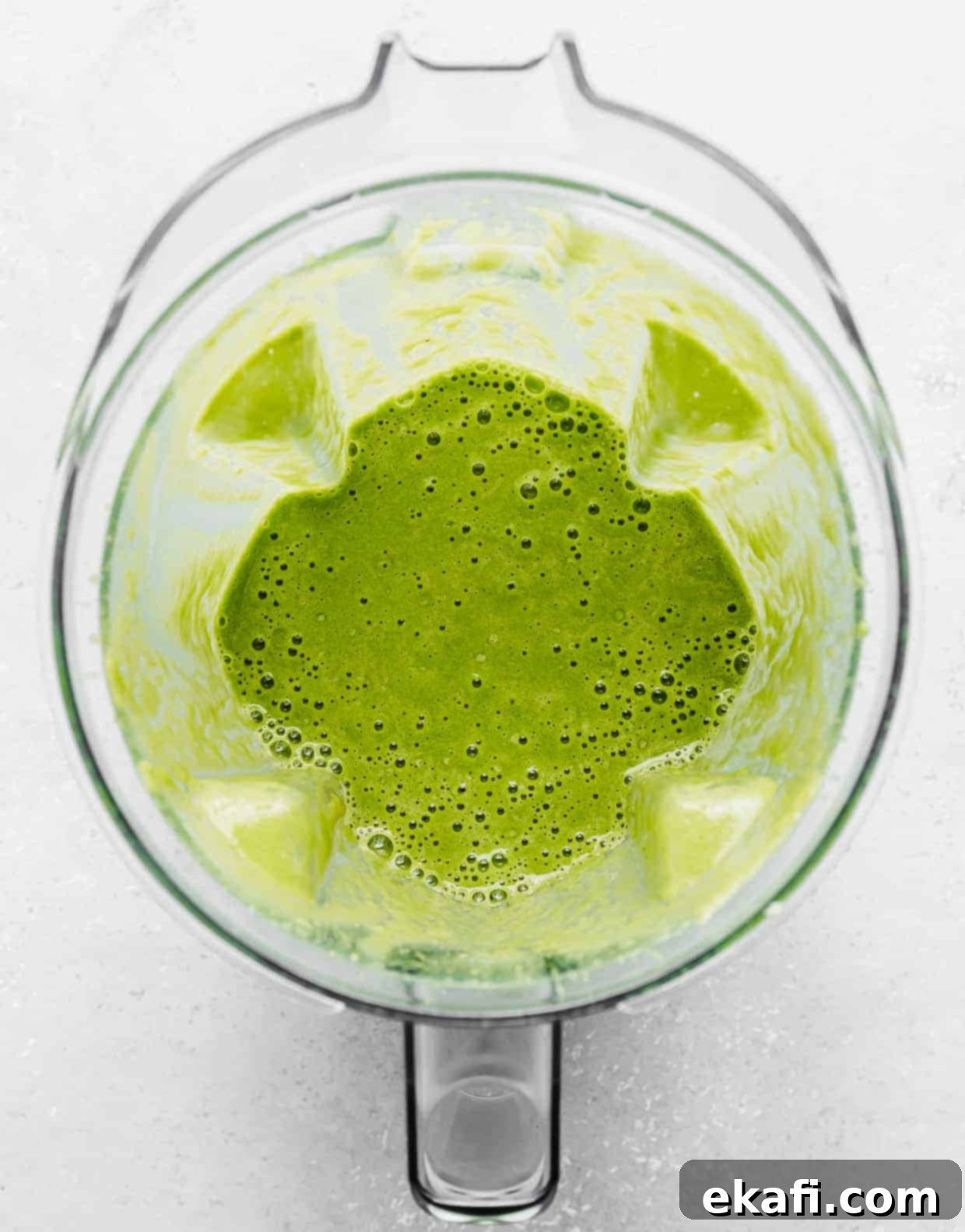 Green Celery Smoothie 5 A blender with bright green celery smoothie in it.