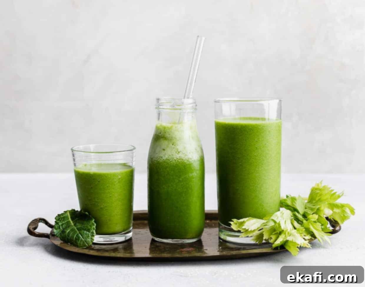Green Celery Smoothie 6 Three glasses full of green celery drink against a white background.