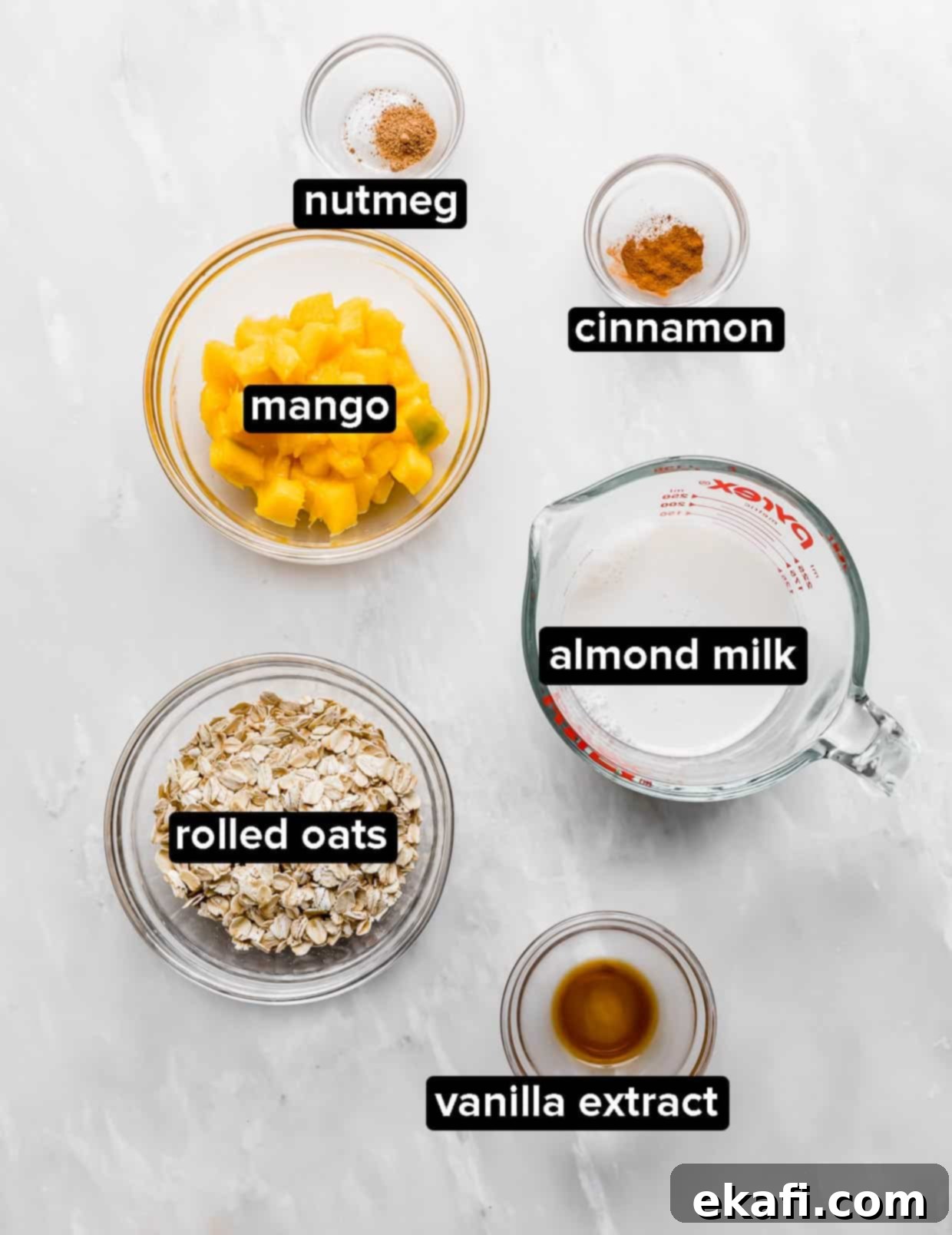 Dreamy Mango Overnight Oats 4 Ingredients used to make mango overnight oats, on a white background.