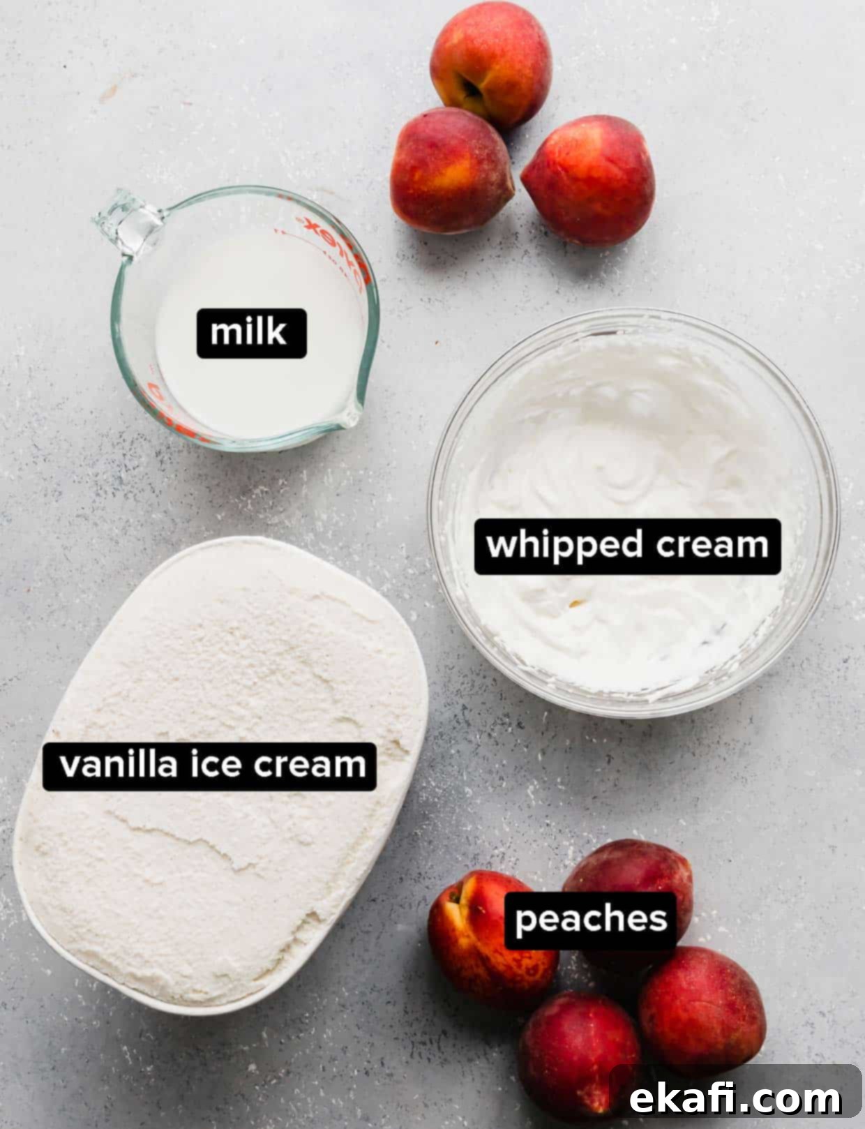 Velvet Peach Shake 3 Fresh peaches, vanilla ice cream, and milk laid out as ingredients for a peach milkshake on a blue surface.