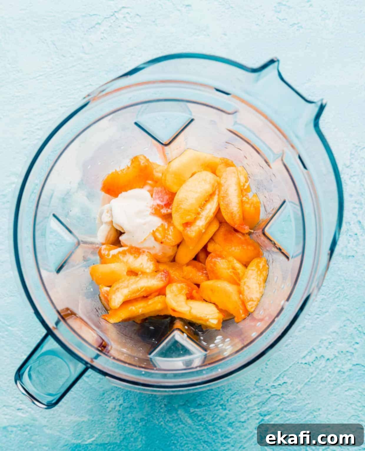 Velvet Peach Shake 4 Sliced peaches, vanilla ice cream, and a splash of milk are ready in a blender to be transformed into a peach milkshake.
