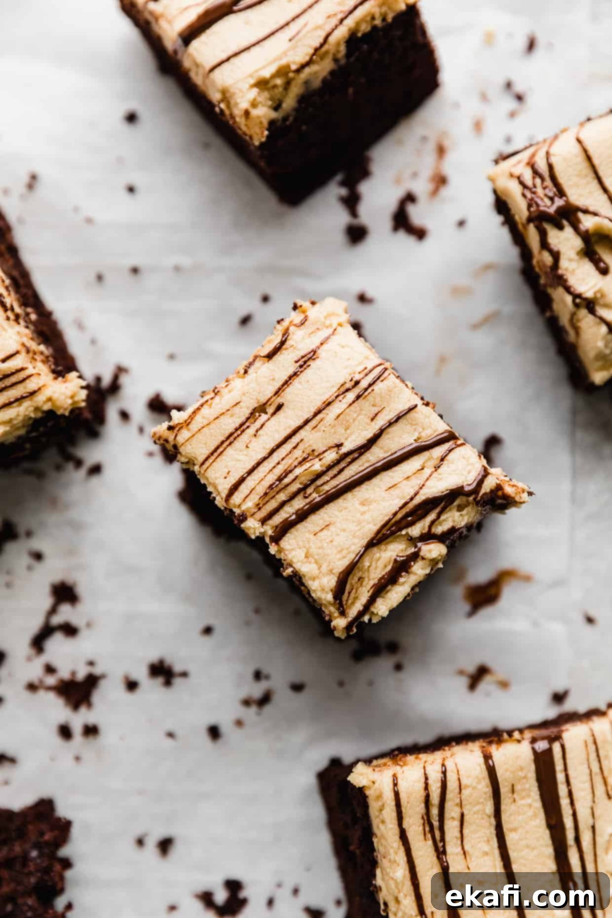 Chocolate Peanut Butter Symphony 2 Overhead photo of a square of rich chocolate cake covered with smooth peanut butter frosting and delicate melted chocolate squiggles.