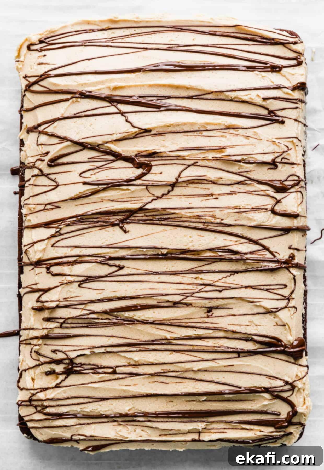 Chocolate Peanut Butter Symphony 12 Melted chocolate artfully drizzled overtop of a Chocolate Cake with Peanut Butter Frosting, adding a decorative and delicious finish.