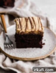 Chocolate Peanut Butter Symphony 15 A slice of square chocolate cake topped with a peanut butter frosting and drizzled with melted chocolate, representing the finished recipe.