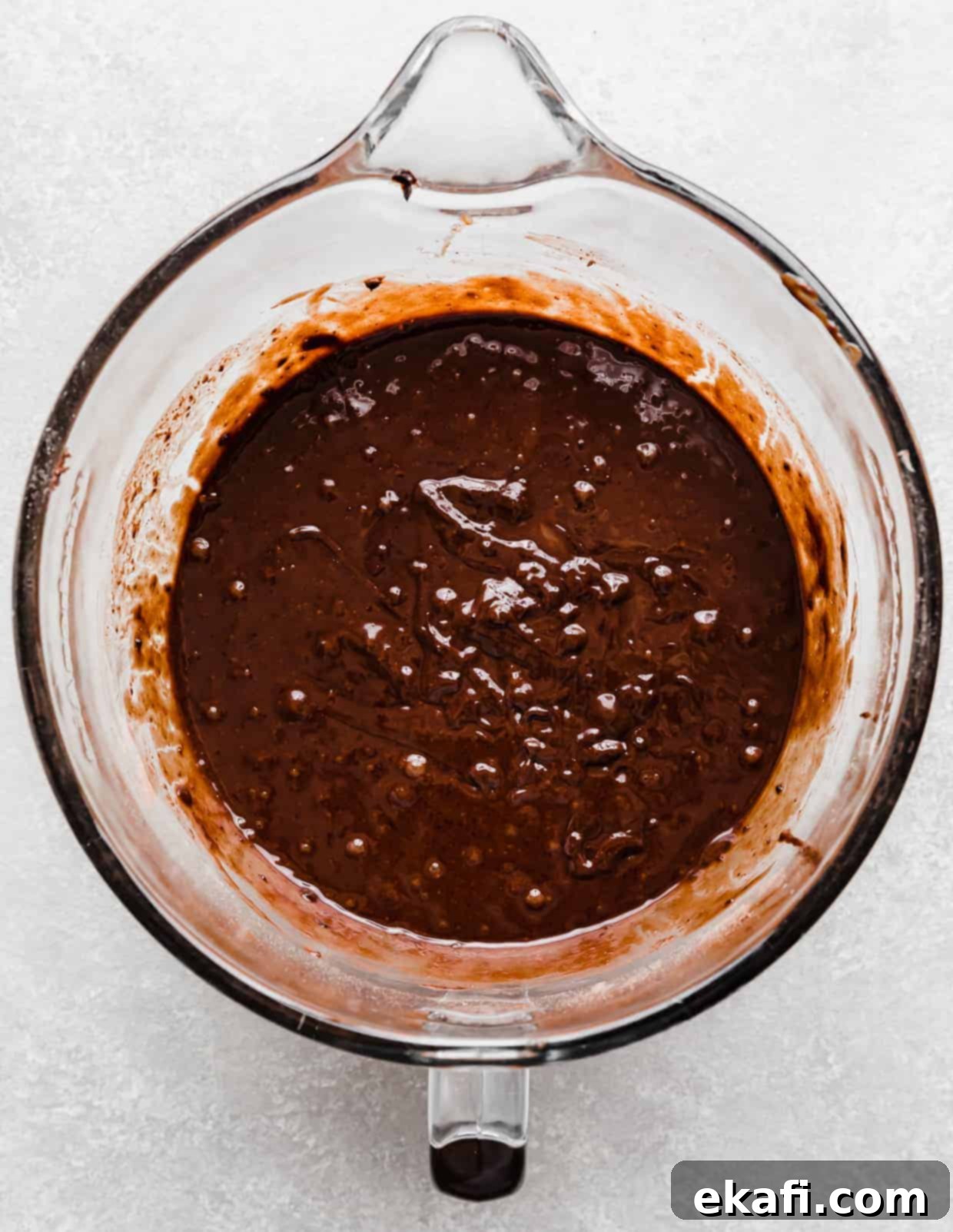 Chocolate Peanut Butter Symphony 7 Smooth, rich chocolate cake batter in a glass stand mixer bowl, ready for baking.