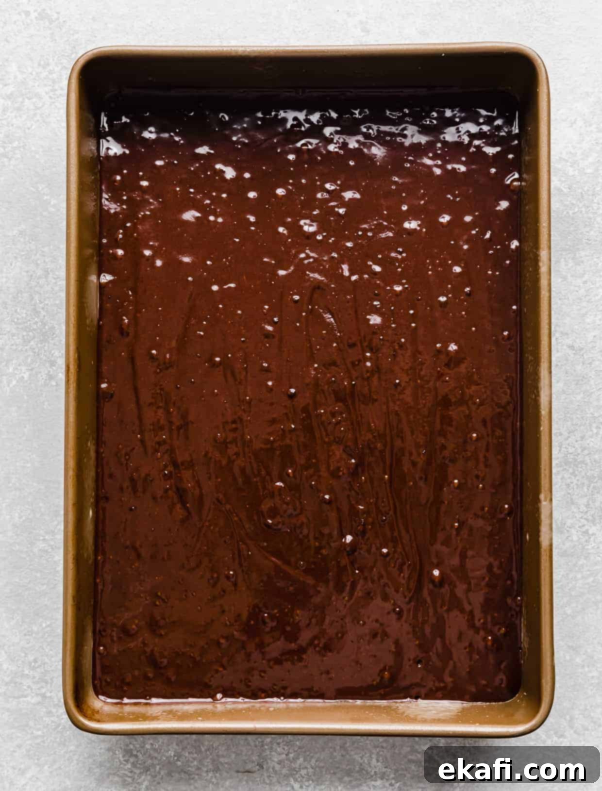 Chocolate Peanut Butter Symphony 8 A 9x13 inch baking pan filled with smooth, prepared chocolate cake batter, ready to be baked.