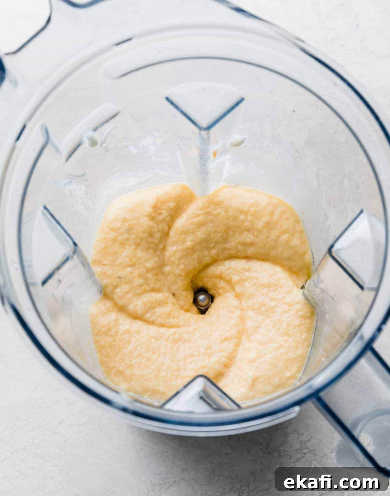 Creamy Peach Banana Bliss 6 A banana peach smoothie mixture pureed in a blender.