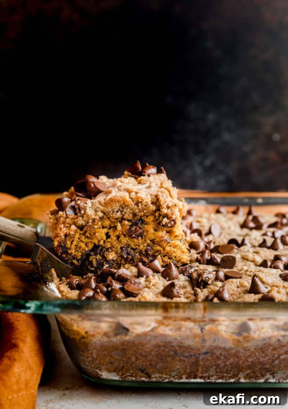 Cozy Pumpkin Chocolate Chip Coffee Cake 16 Pumpkin Chocolate Chip Coffee Cake against a brown background.