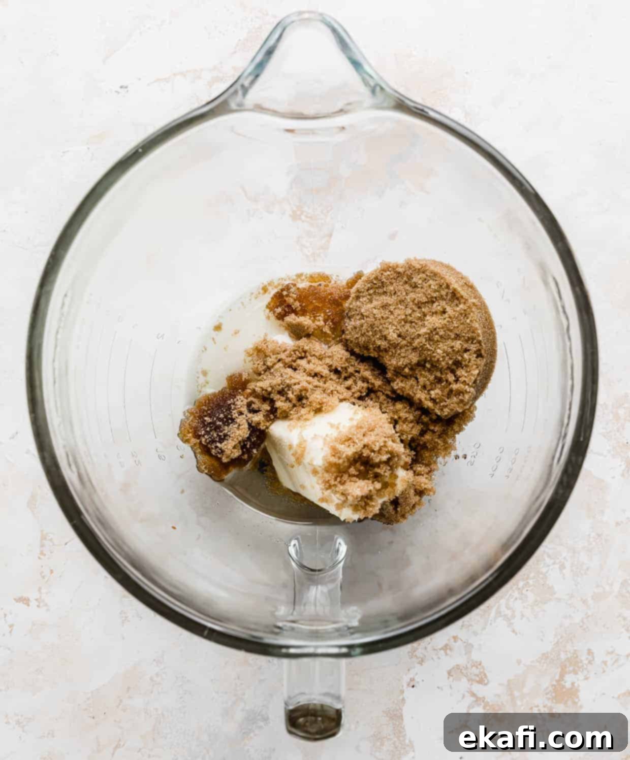 Cozy Pumpkin Chocolate Chip Coffee Cake 6 A glass stand mixer bowl with brown sugar and butter in it.