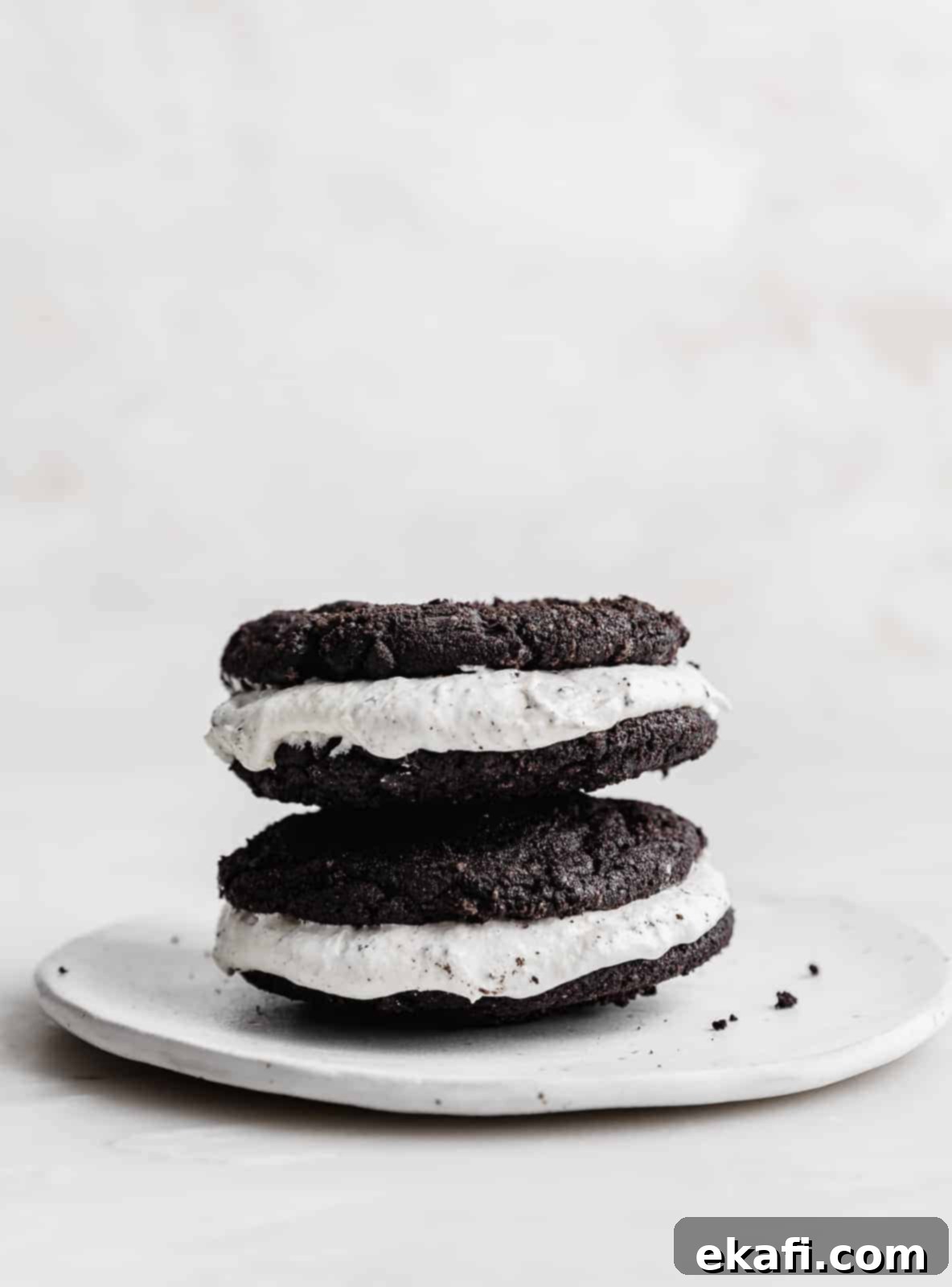 Crumbl Oreo Cookie Sandwiches 3 Two Crumbl giant oreo sandwich cookies stacked on top of each other.