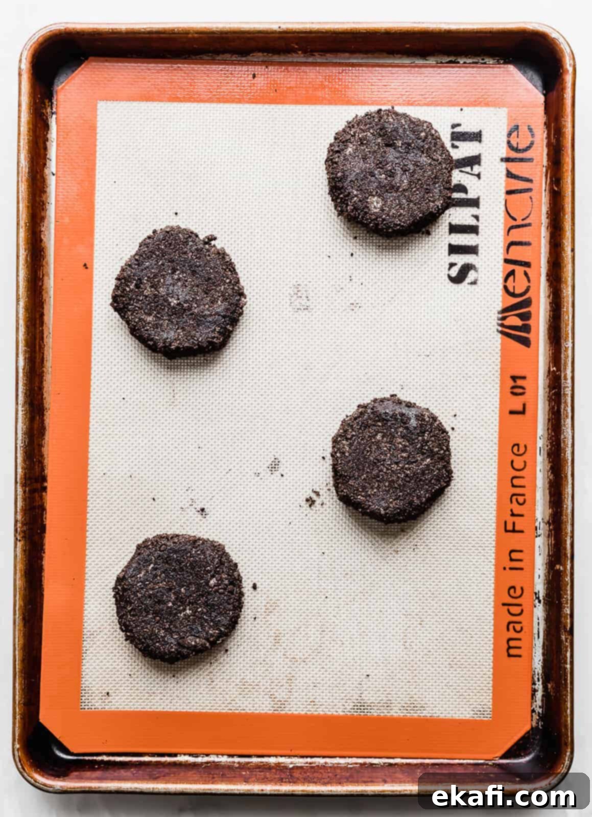 Crumbl Oreo Cookie Sandwiches 5 Black cookie dough batter balls on a baking sheet.