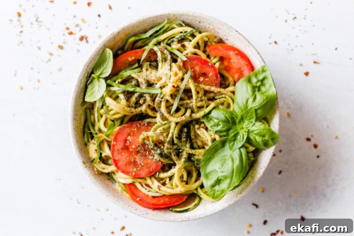 Fluted Zucchetti 5 A delicious 5-Minute Cheesy Zucchetti Bowl, featuring vibrant zucchini noodles tossed in a creamy sauce, topped with fresh tomatoes and basil.