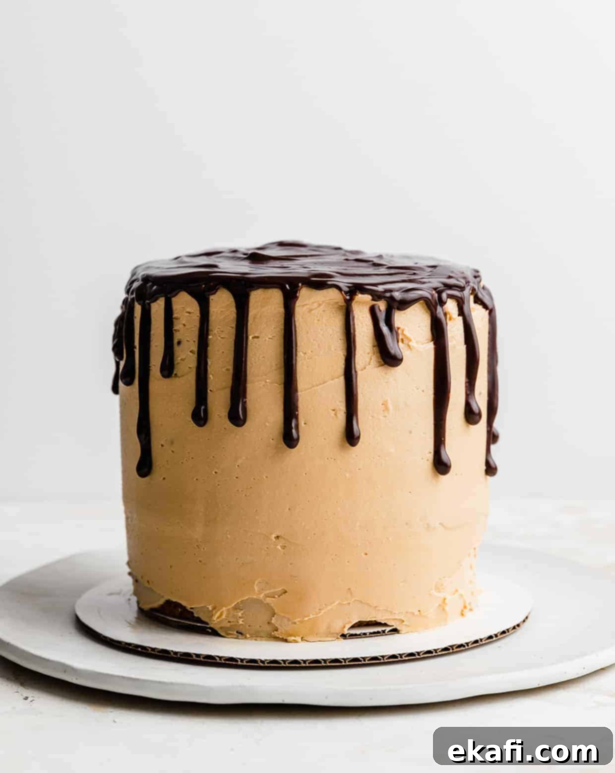 Seven-Layer Cake Bars 7 A stunning 7 Layer Bar Cake, fully covered in creamy butterscotch buttercream, with a rich chocolate ganache drip elegantly cascading down its sides.