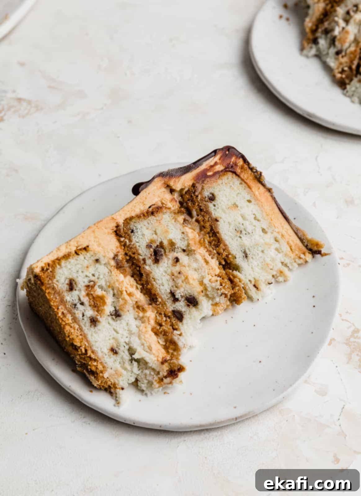 Seven-Layer Cake Bars 8 A beautiful slice of 7 Layer Bar Cake, showing off its distinct layers, perfectly presented on a white plate, ready to be enjoyed.