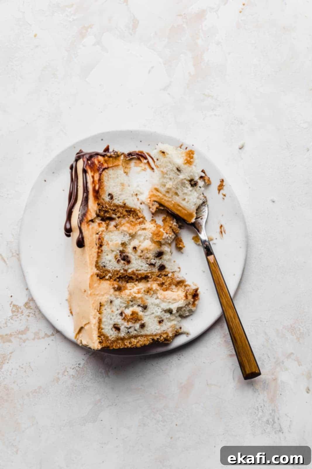 Seven-Layer Cake Bars 9 A fork gently cutting into a thick slice of 7 Layer Bar Cake, revealing the soft cake and luscious filling, ready for a delicious bite.