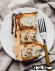 Seven-Layer Cake Bars 10 A slice of 7 Layer Bar Cake on a white plate, showcasing its beautiful layers.