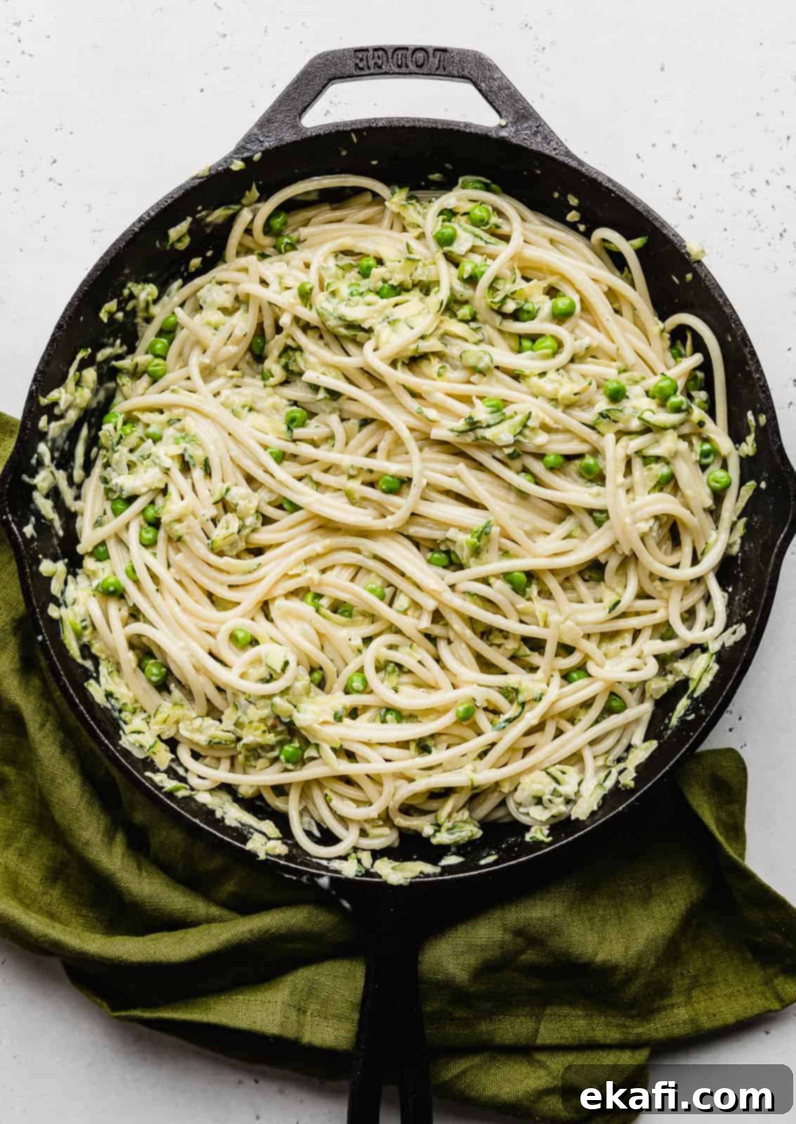 Summer Zucchini Delight 11 Pasta with Zucchini Sauce in a black skillet against a white background.