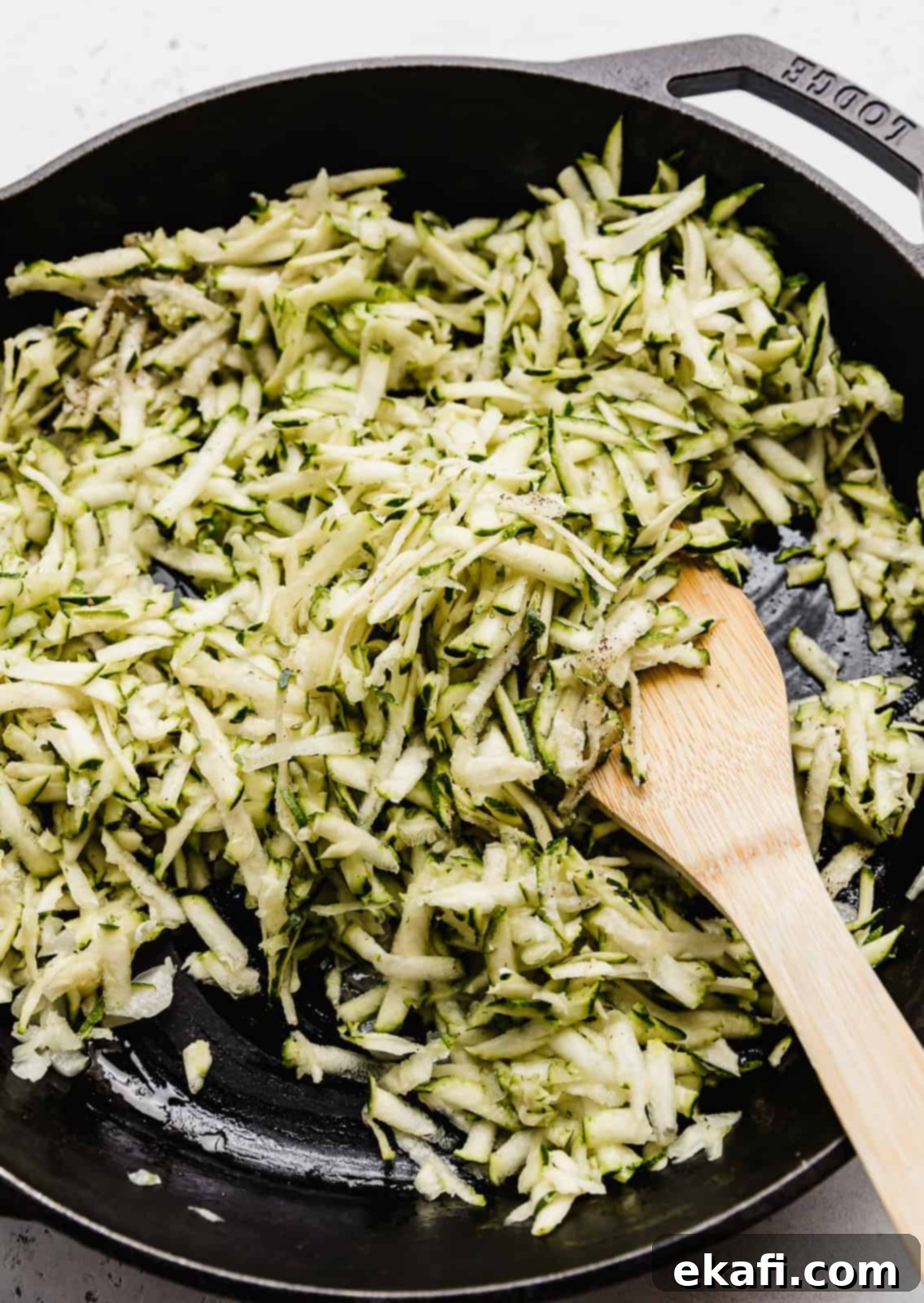 Summer Zucchini Delight 5 Close up photo of shredded zucchini in a black skillet.
