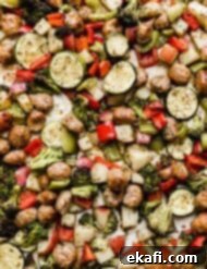 One Pan Roasted Italian Sausage and Vibrant Vegetables 10 Sheet Pan Sausage and Veggies on a baking sheet.