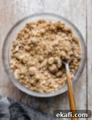 Crumbly Delight 9 A bowl of Streusel Topping on a light wooden background.