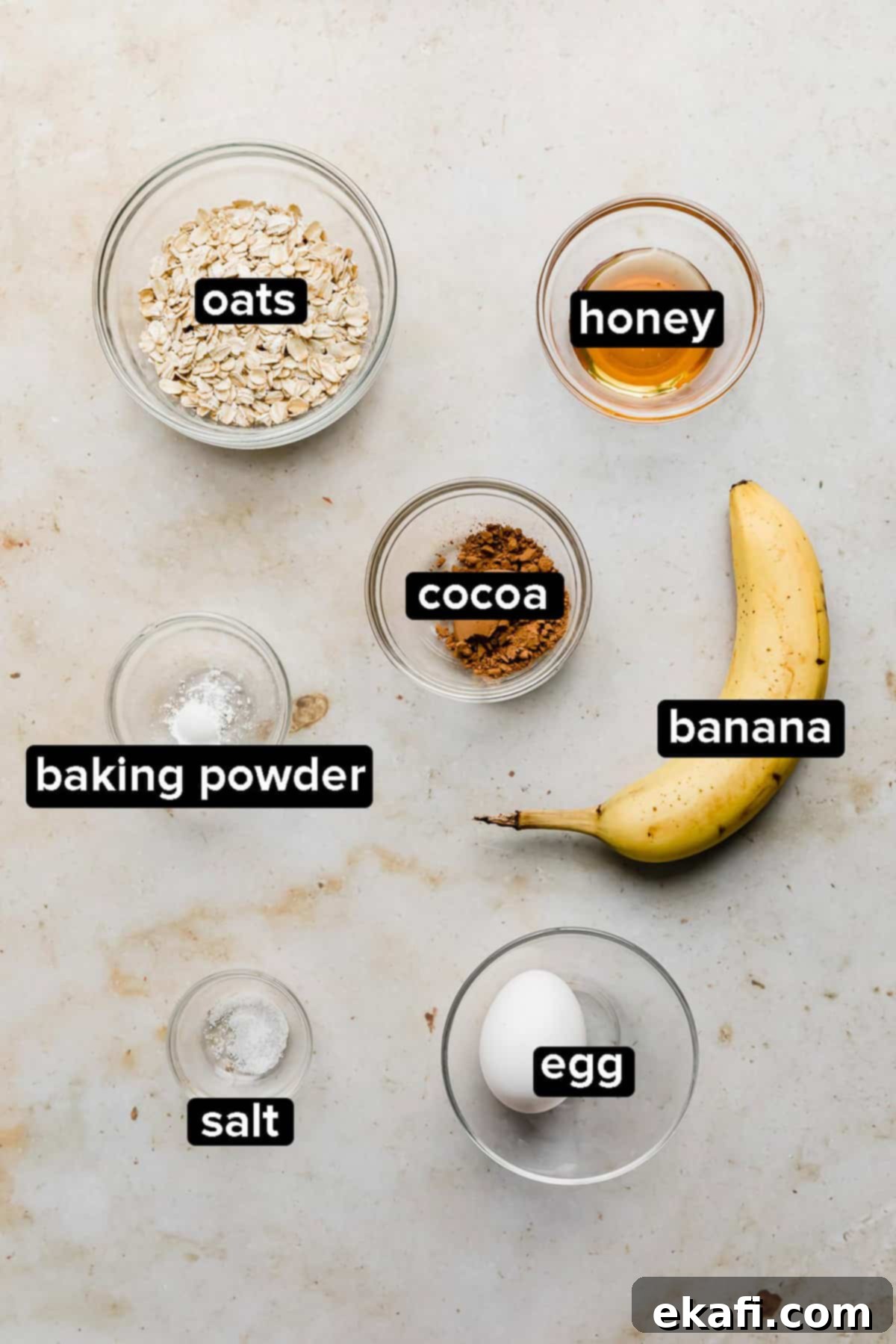 Chocolate Baked Oats Perfection 3 Chocolate Baked Oats ingredients on a cream colored background.