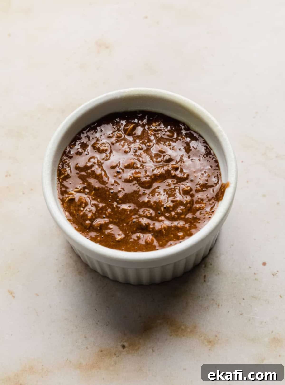 Chocolate Baked Oats Perfection 6 A white ramekin with Chocolate Baked Oats batter in it.