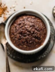 Chocolate Baked Oats Perfection 8 Chocolate Baked Oats in a white ramekin on a cream background.